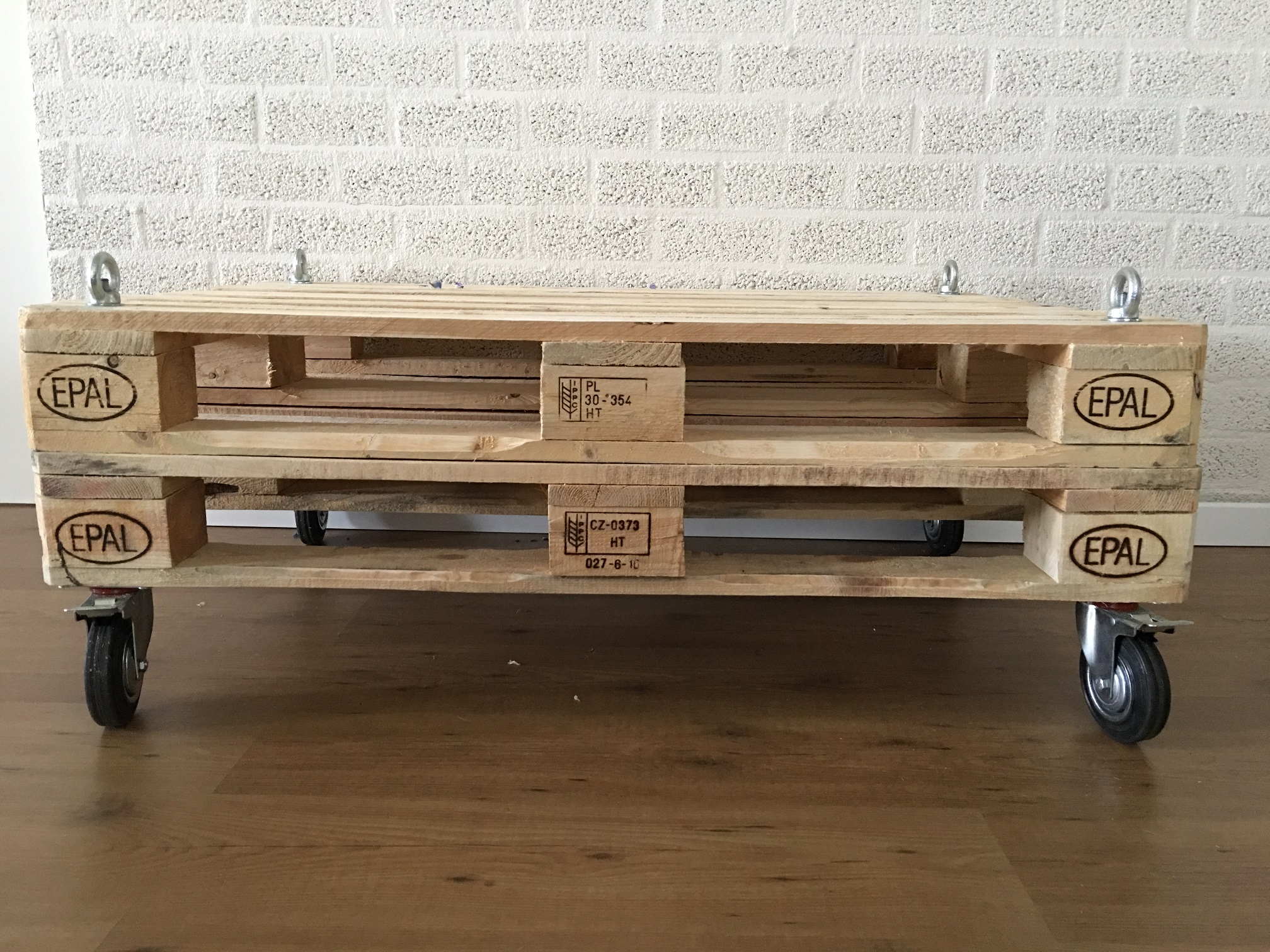 Prachtige basismodel pallethouten industriële tafel op 4 zwenkwielen met rem